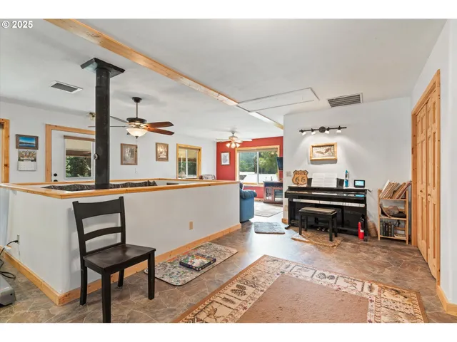 a living room with furniture and a piano