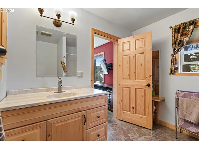 a bathroom with a sink a vanity and a mirror