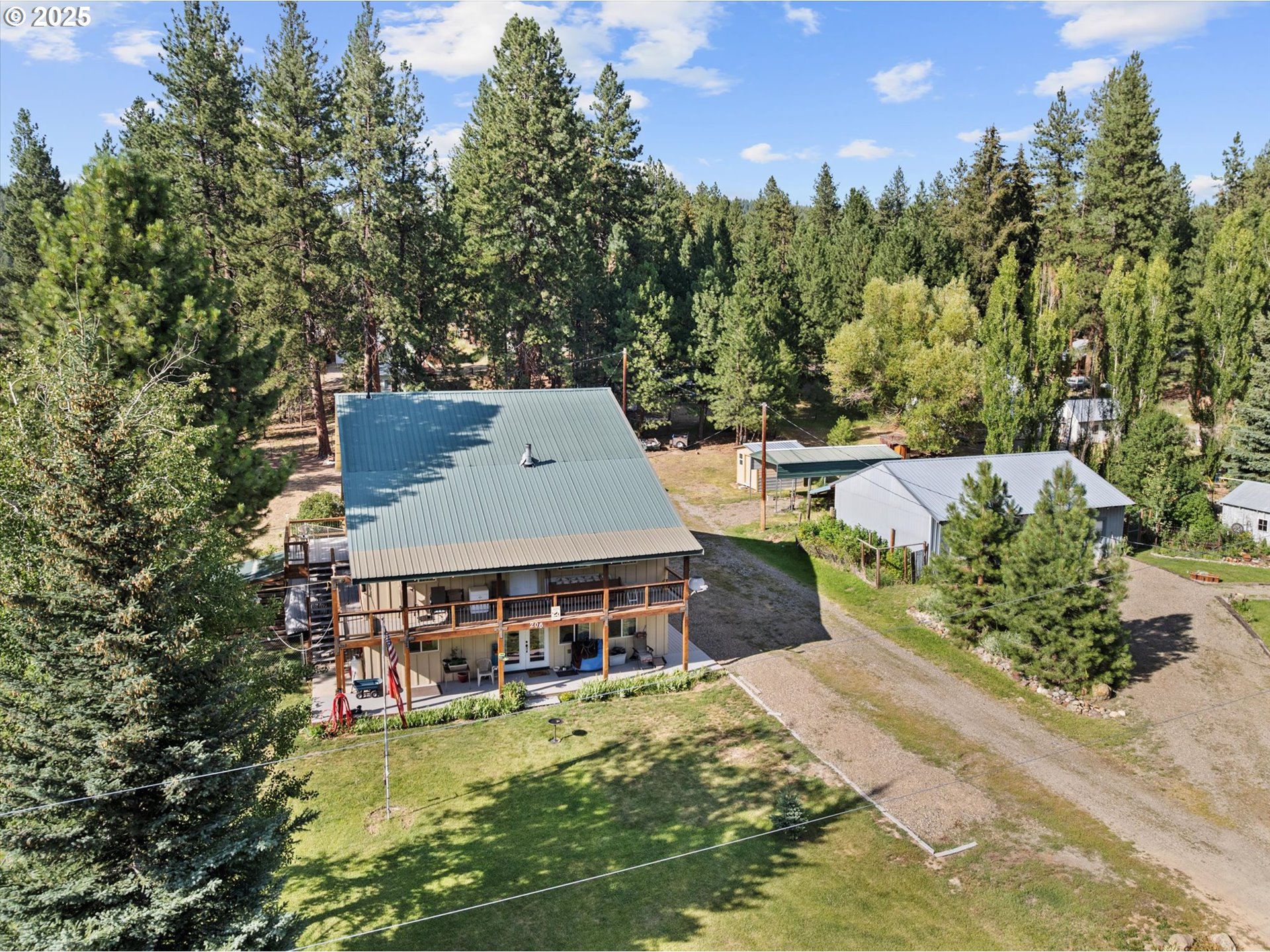 206 Austin Street Sumpter, OR 97877 - Photo 9 of 48 an aerial view of a house with swimming pool and tennis court