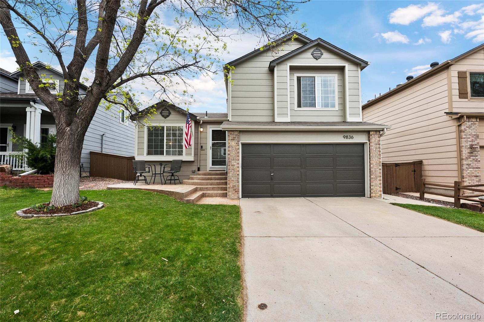 a front view of a house with a yard and garage