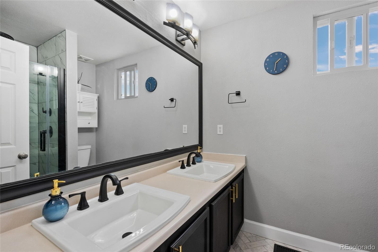 9836 South Castle Ridge Circle Highlands Ranch, CO 80129 - Photo 12 of 28 a bathroom with a sink vanity and a mirror