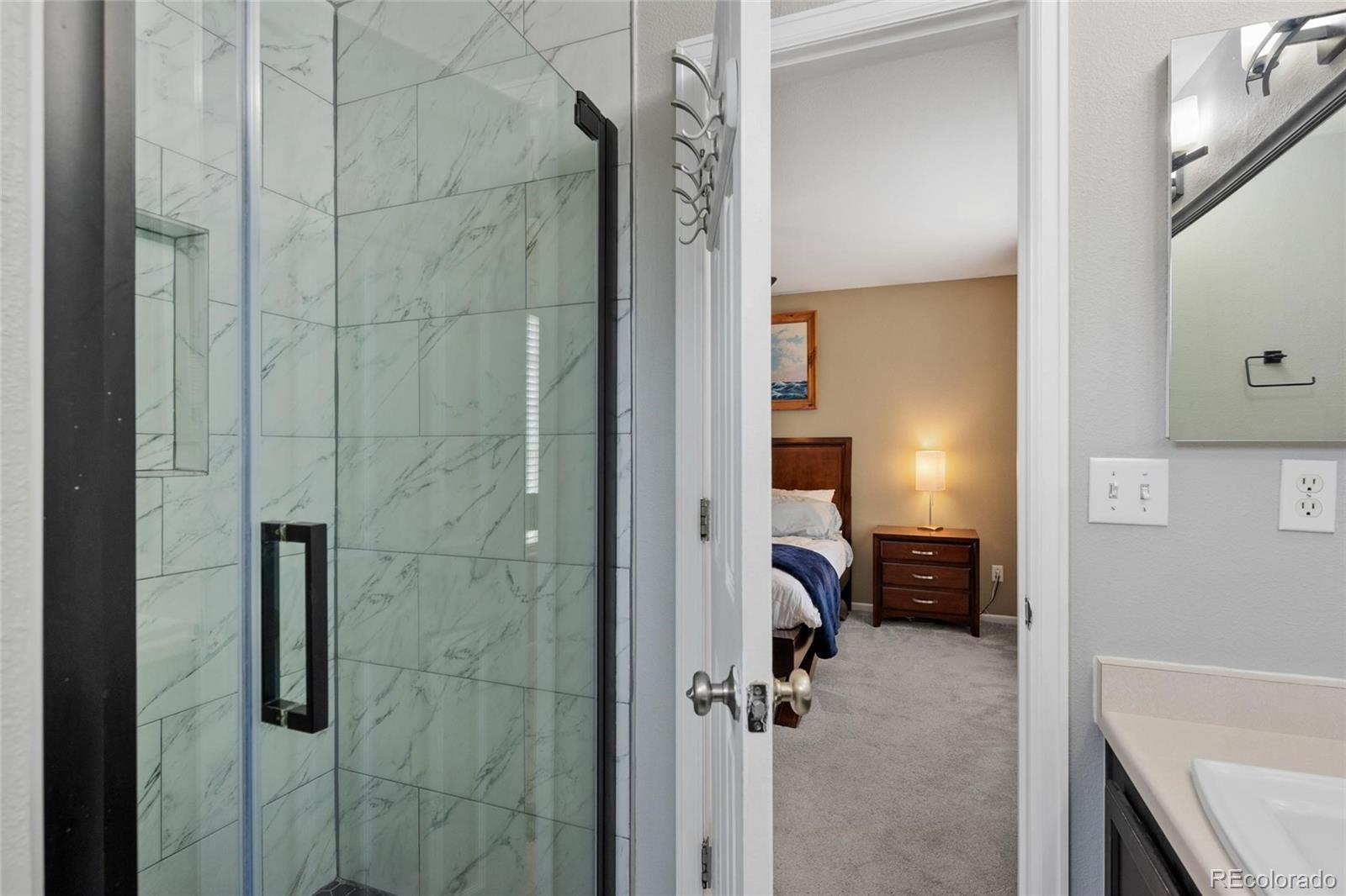 9836 South Castle Ridge Circle Highlands Ranch, CO 80129 - Photo 13 of 28 a bathroom with a tub and a shower