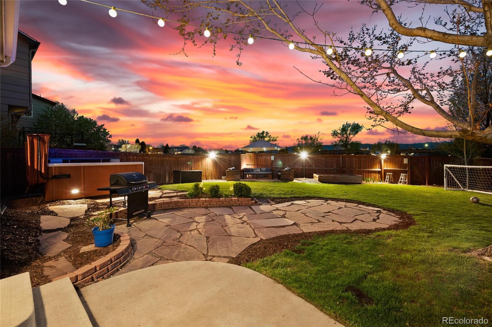 9836 South Castle Ridge Circle Highlands Ranch, CO 80129 - Photo 2 of 28 a backyard of a house with table and chairs