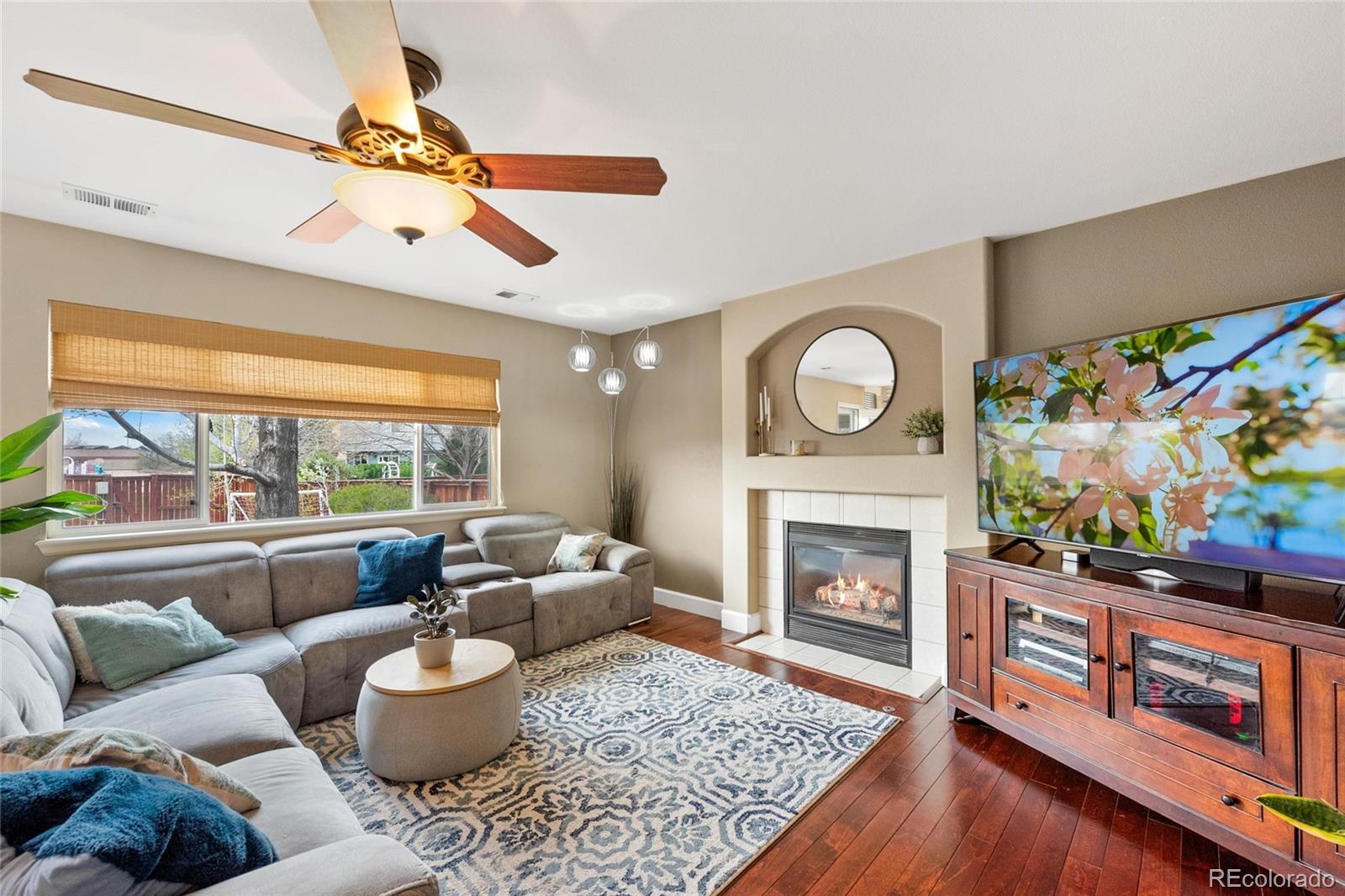 9836 South Castle Ridge Circle Highlands Ranch, CO 80129 - Photo 7 of 28 a living room with furniture and a fireplace
