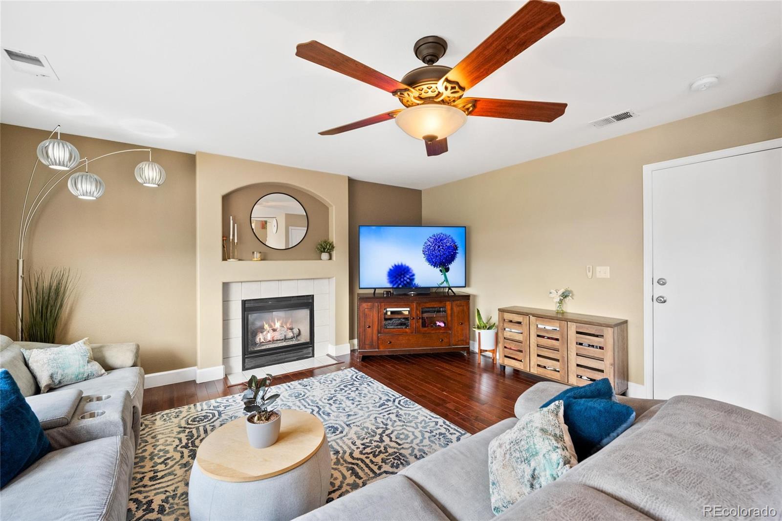 9836 South Castle Ridge Circle Highlands Ranch, CO 80129 - Photo 9 of 28 a living room with furniture a fireplace and a flat screen tv