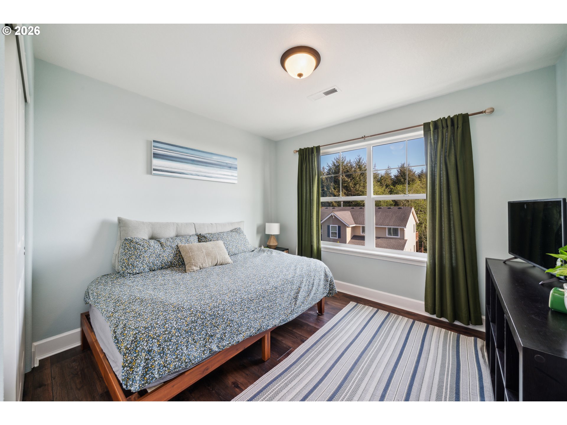 4300 Sequoia Loop Netarts, OR 97141 - Photo 26 of 39 a bedroom with a bed and a window