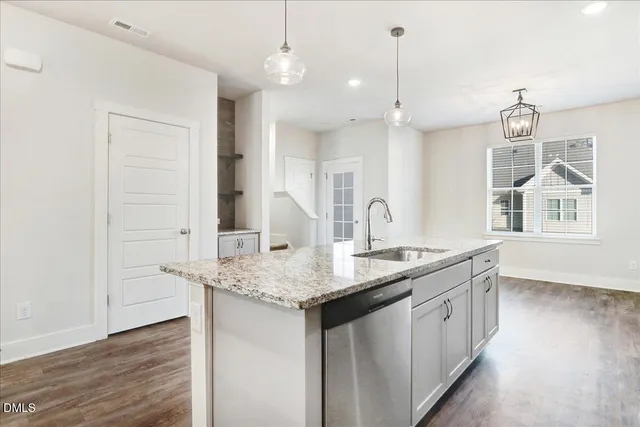 a kitchen with center island wooden floor and a chandelier