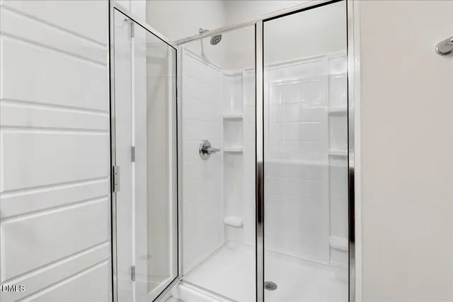 a bathroom with a glass shower door