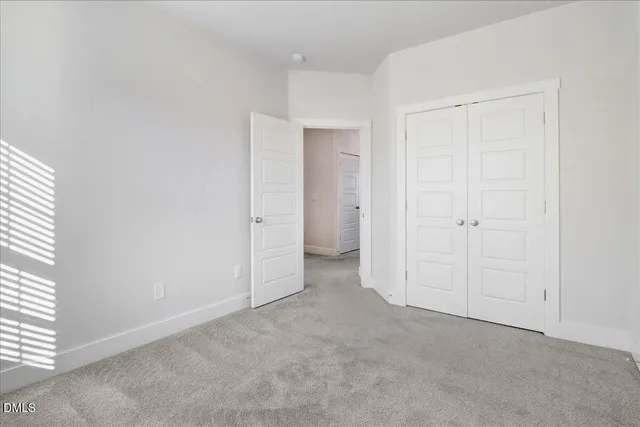 an empty room with closet area