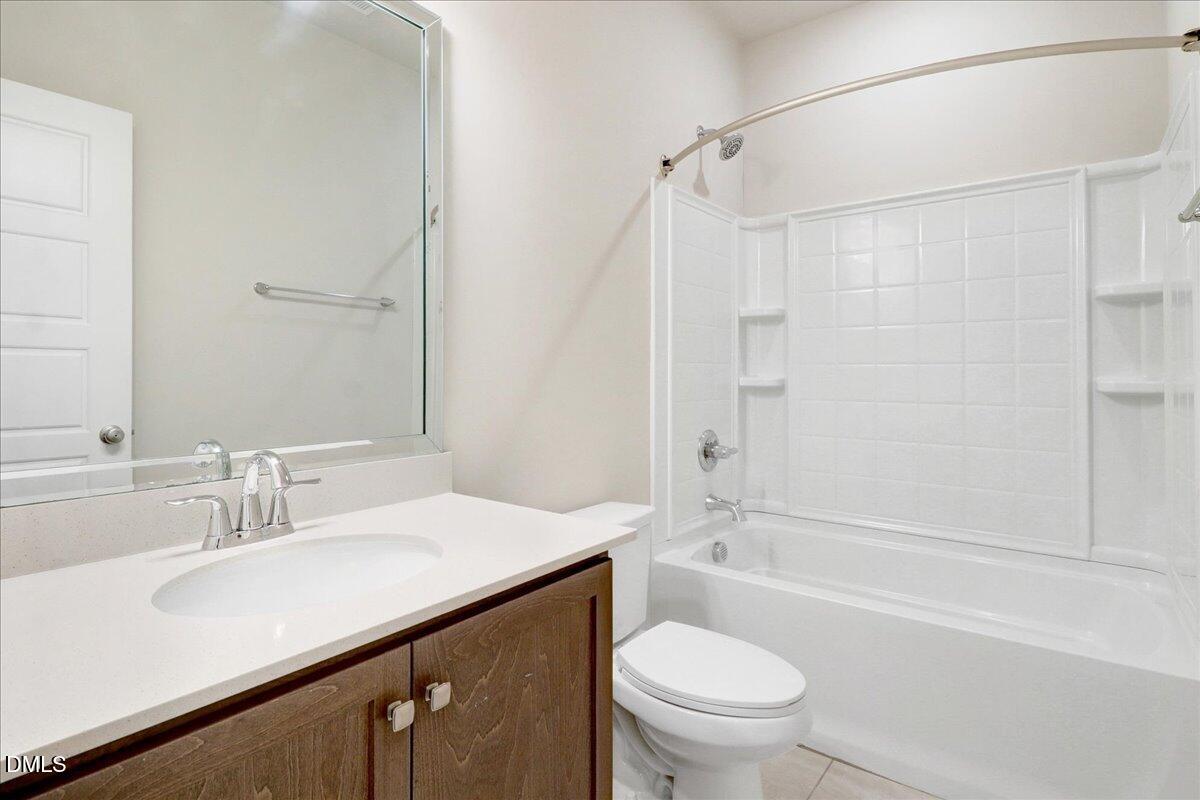 857 South Franklin Street Wake Forest, NC 27587 - Photo 23 of 30 a bathroom with a sink a toilet and a bathtub