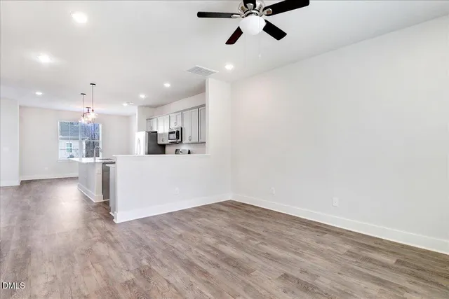 a view of a kitchen with a sink and wooden floor
