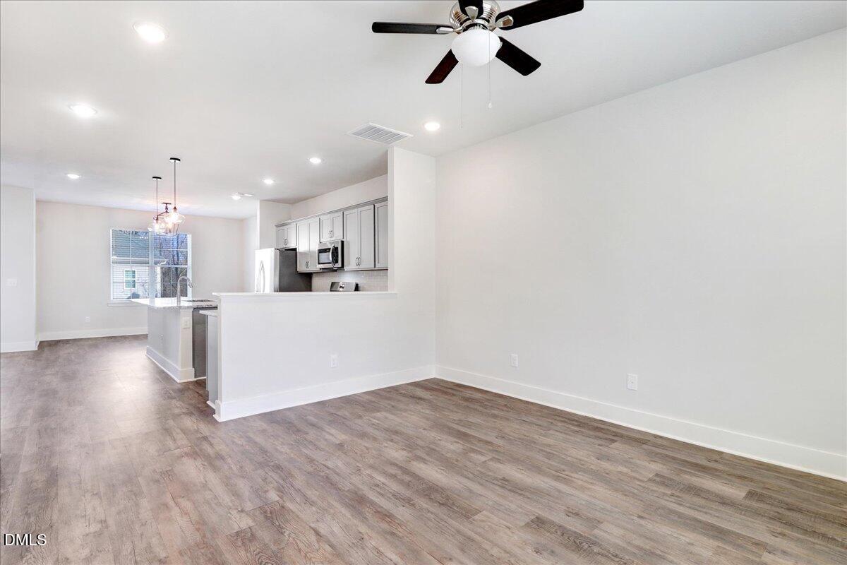 857 South Franklin Street Wake Forest, NC 27587 - Photo 6 of 30 a view of a kitchen with a sink and wooden floor