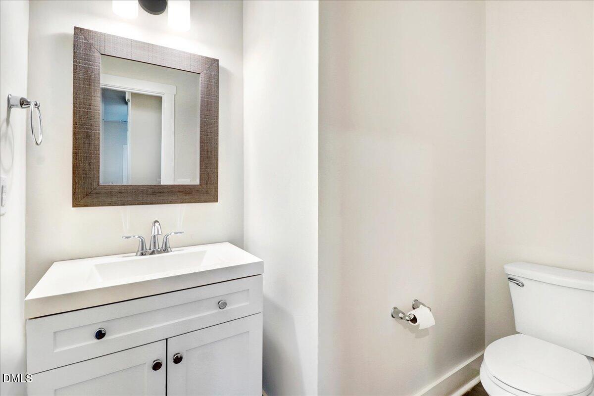 857 South Franklin Street Wake Forest, NC 27587 - Photo 7 of 30 a bathroom with a toilet sink and mirror