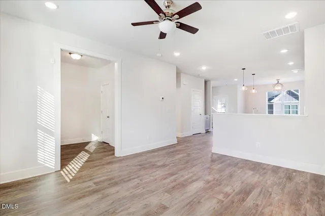 a view of an empty room and wooden floor