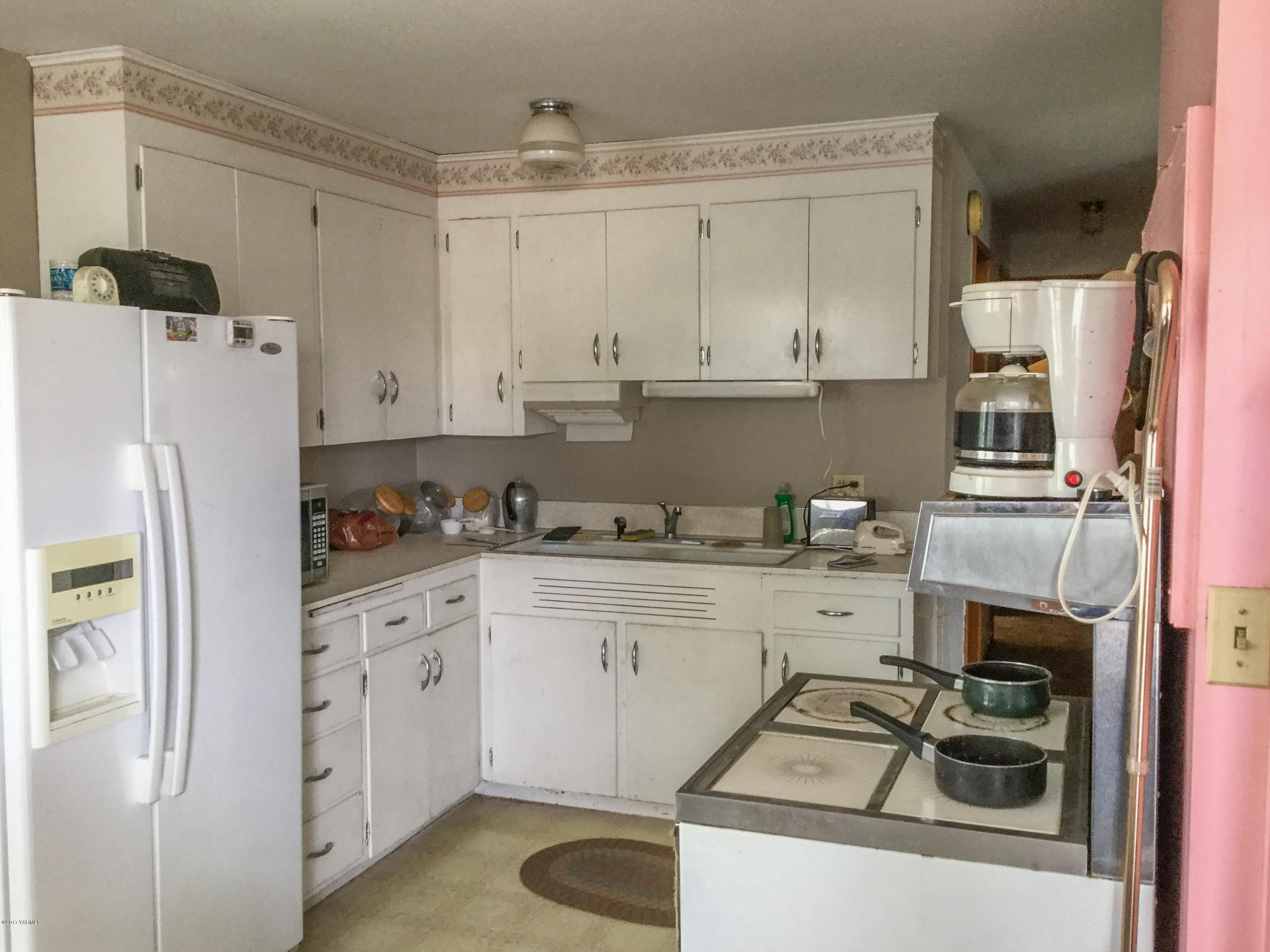 380 North Rivard Road Moxee, WA 98936 - Photo 7 of 12 a kitchen with a sink a stove and refrigerator