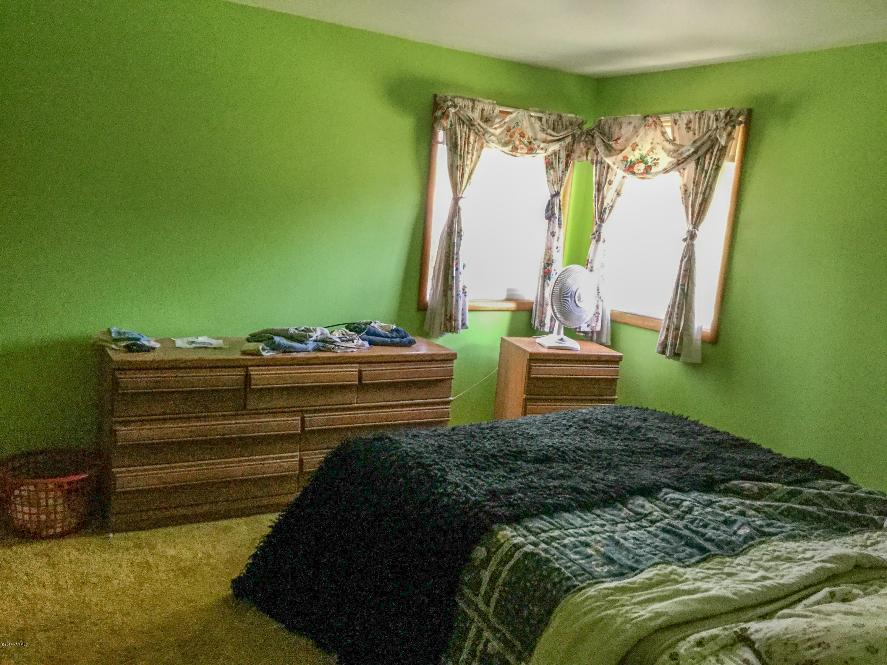 380 North Rivard Road Moxee, WA 98936 - Photo 8 of 12 a bedroom with a bed and a chair