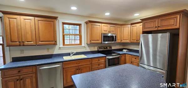 a view of a hallway with wooden floor and stairs