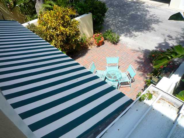 837 Camelia Lane, Unit 7 Vero Beach, FL 32963 - Photo 5 of 20 a view of a flower garden with wooden fence