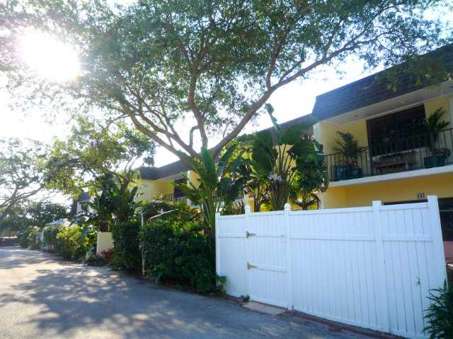 837 Camelia Lane, Unit 7 Vero Beach, FL 32963 - Photo 6 of 20 a view of backyard with swimming pool and wooden fence