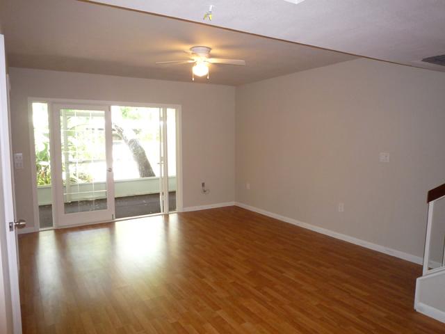 837 Camelia Lane, Unit 7 Vero Beach, FL 32963 - Photo 9 of 20 a view of an empty room with wooden floor and a window