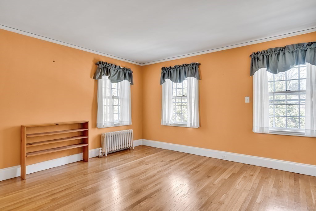11 Edgewood Road Lexington, MA 02420 - Photo 15 of 22 an empty room with wooden floor and windows