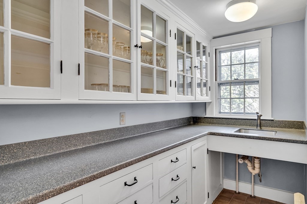 11 Edgewood Road Lexington, MA 02420 - Photo 8 of 22 a kitchen with granite countertop white cabinets and a sink