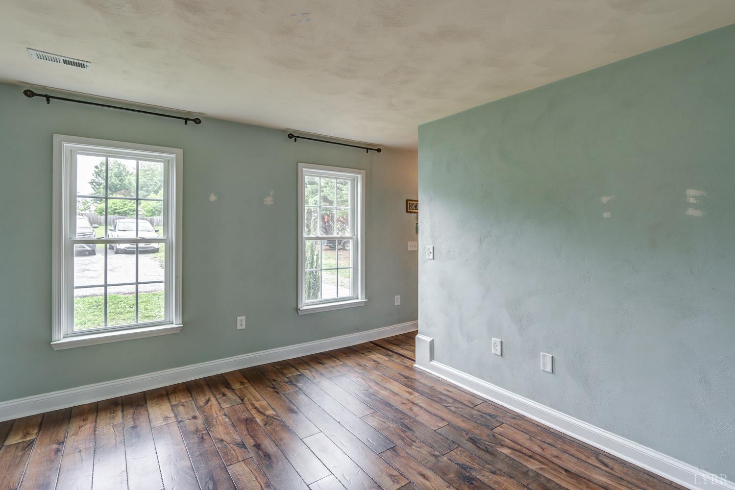 1057 Old Trail Road Forest, VA 24551 - Photo 21 of 49 a view of an empty room with wooden floor and a window