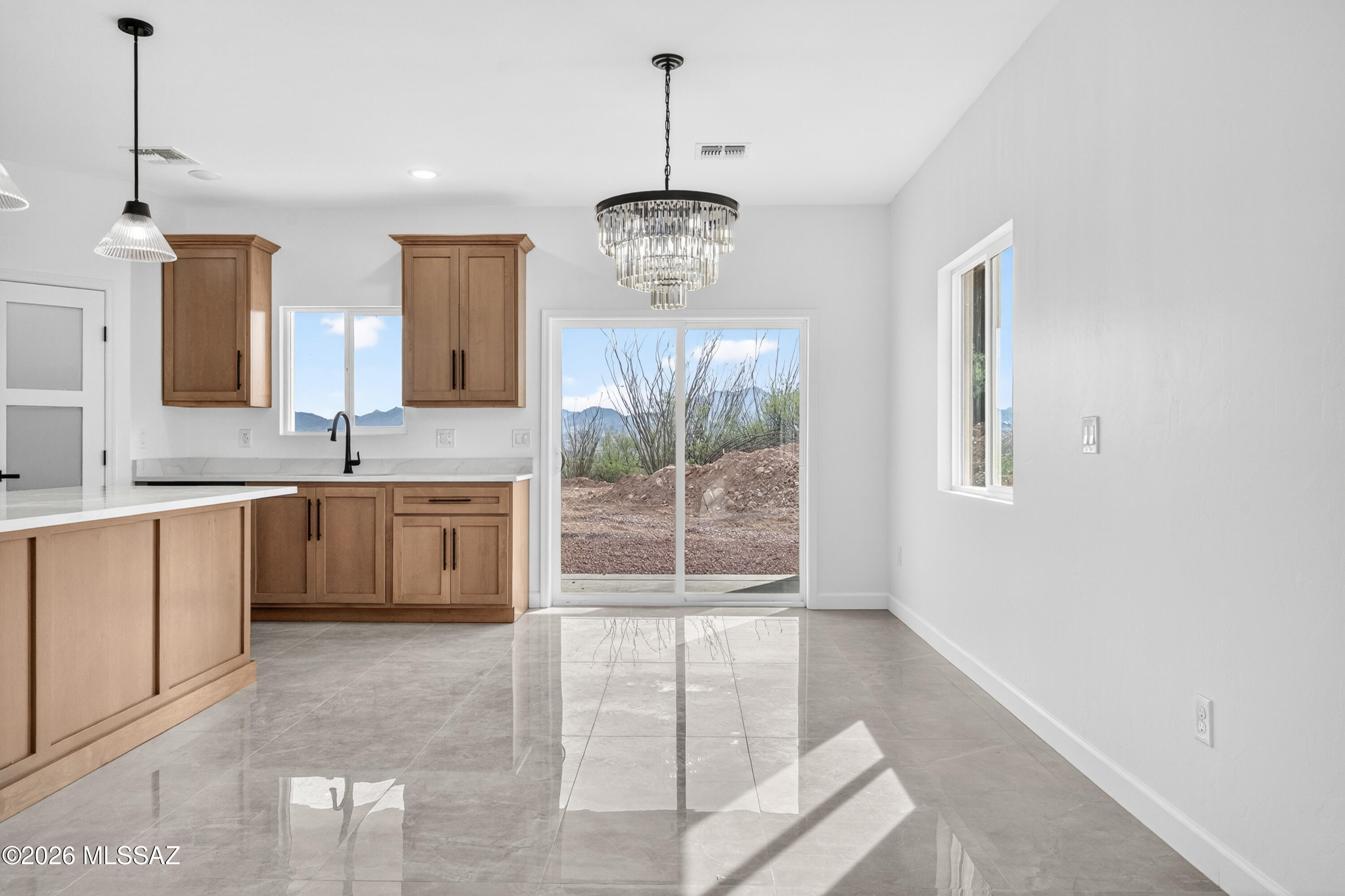 1834 Circulo Glorieta Rio Rico, AZ 85648 - Photo 12 of 35 a kitchen with kitchen island granite countertop a stove a sink and a granite counter tops