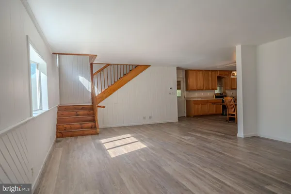 a view of hallway with stairs and wooden floor