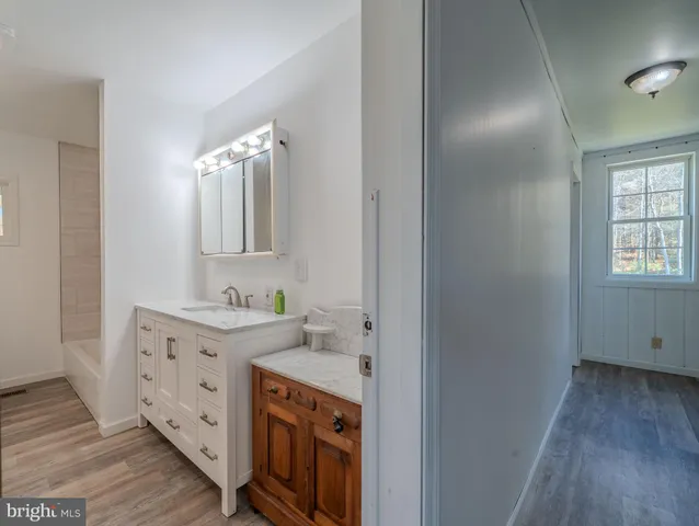 a spacious bathroom with a double vanity sink and a mirror