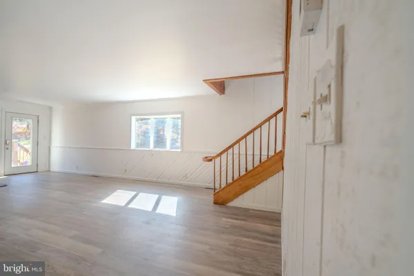 a view of an entryway with wooden floor