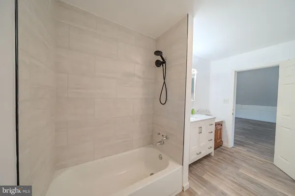 a bathroom with a bathtub and a shower