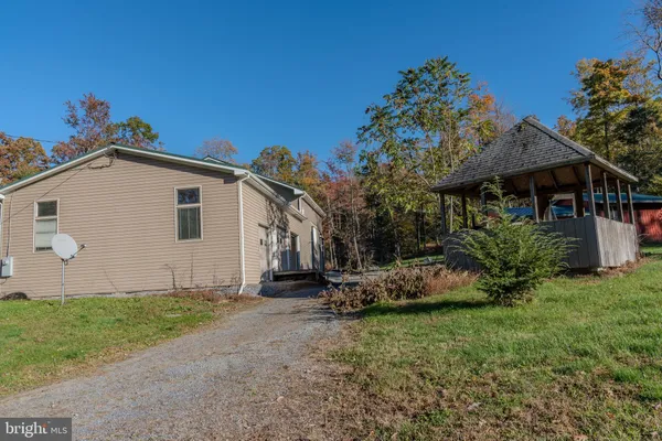 a view of a house with a yard and sitting area