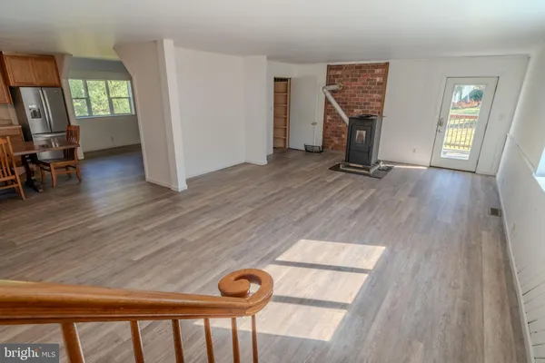 a view of empty room with furniture and a window