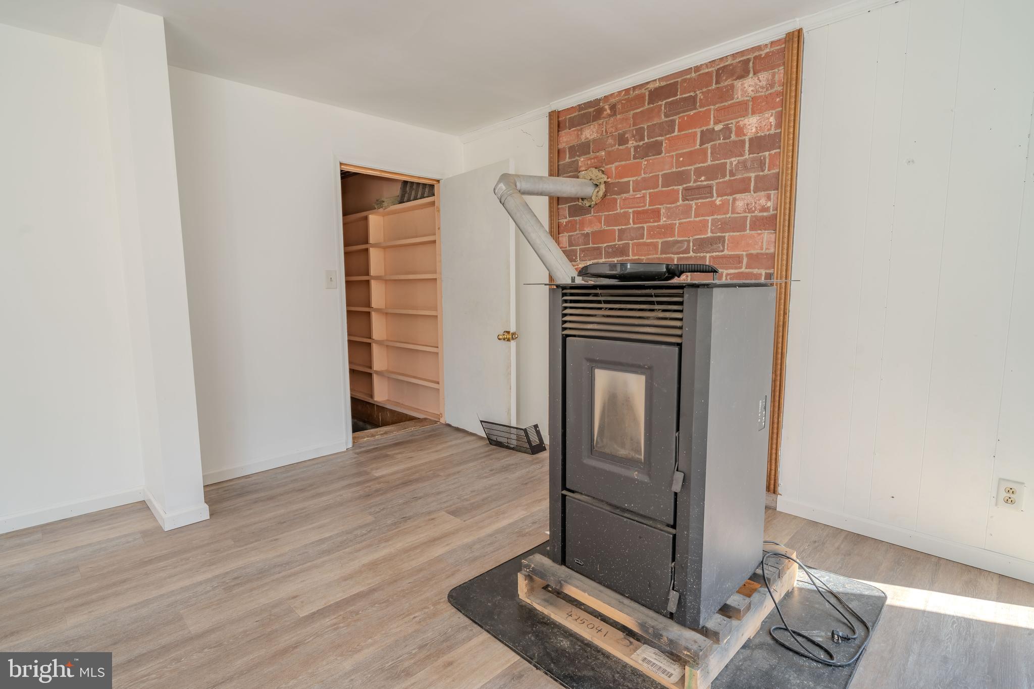 644 Madisonburg Pike Road Madisonburg, PA 16852 - Photo 10 of 44 an empty room with wooden floor cabinet and windows