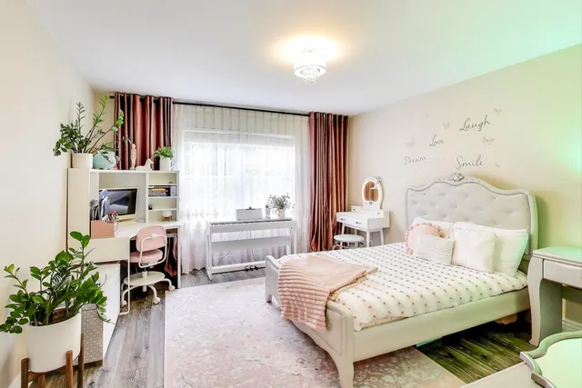 a bedroom with a bed and a large window