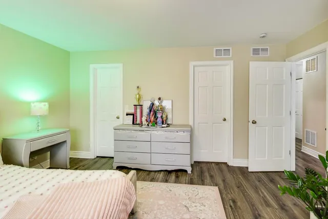 a bed room with a bed and a mirror