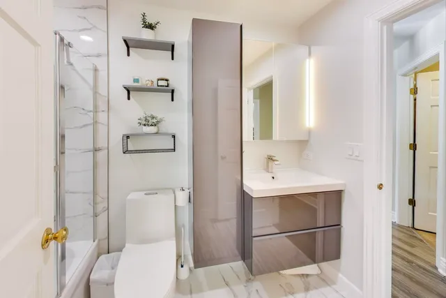 a bathroom with a toilet a sink and shower