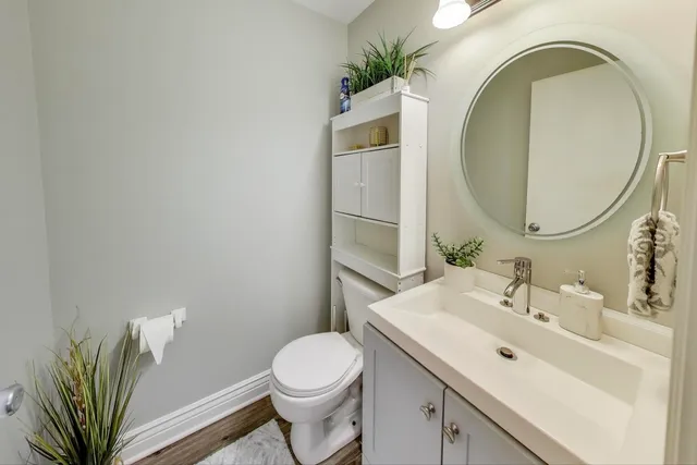 a bathroom with a sink a mirror and toilet