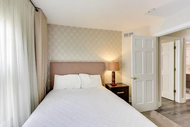 a bedroom with a bed and a mirror