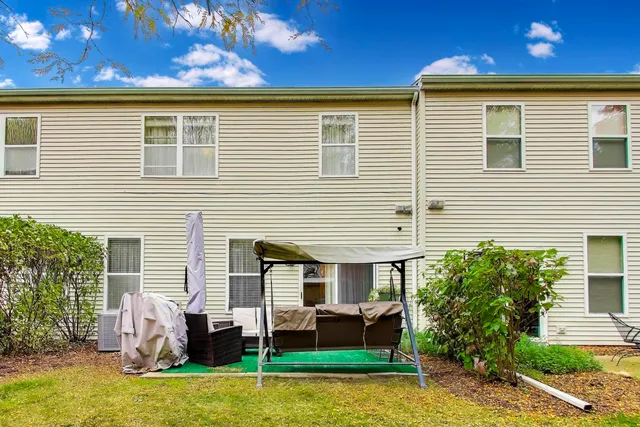 a view of a house with a backyard