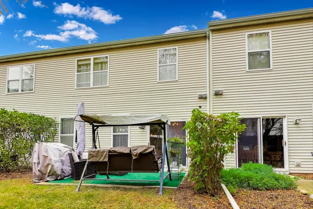 a backyard of a house with yard and outdoor seating