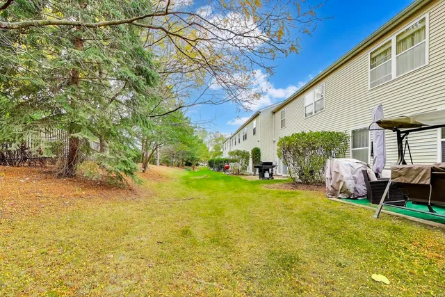 a view of a patio with table and chairs under an umbrella