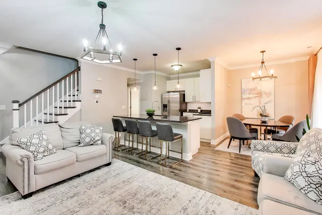 a living room with furniture and a chandelier