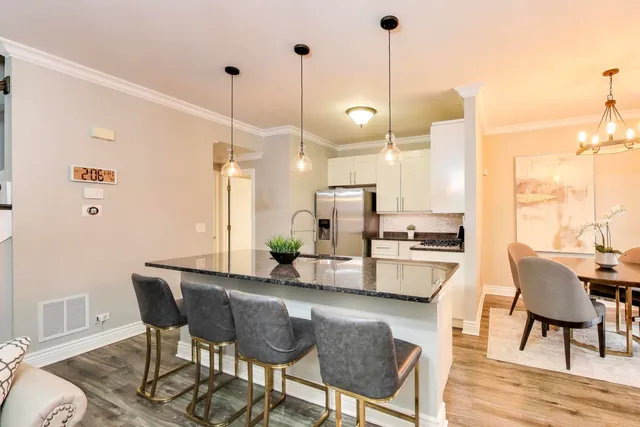 a dining room with furniture and wooden floor