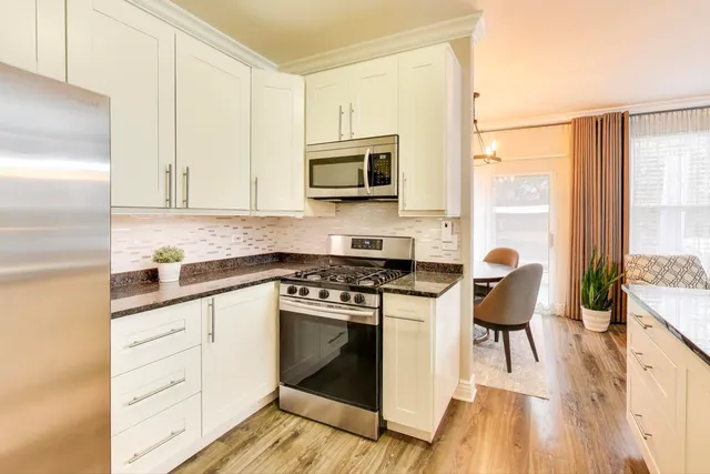 a kitchen with a stove top oven and sink