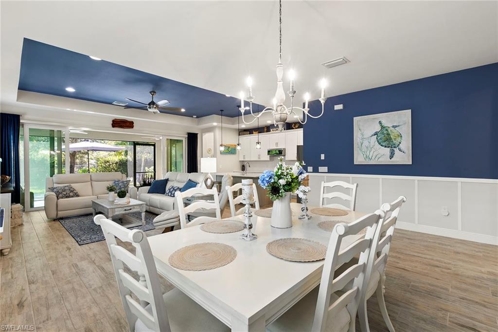 14796 Windward Lane Naples, FL 34114 - Photo 11 of 50 a view of a dining room with furniture window and wooden floor