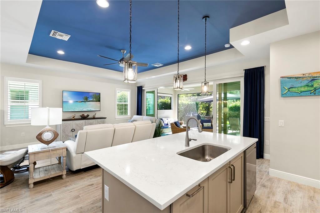 14796 Windward Lane Naples, FL 34114 - Photo 17 of 50 a living room with furniture a flat screen tv and a large window