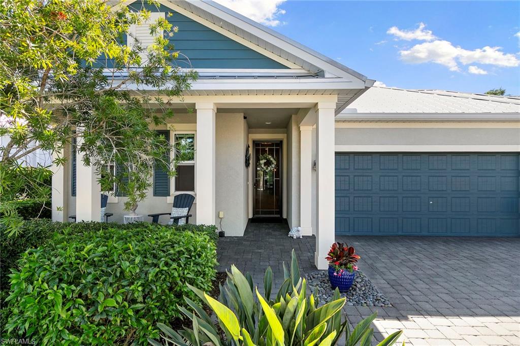 14796 Windward Lane Naples, FL 34114 - Photo 2 of 50 a front view of a house with a porch