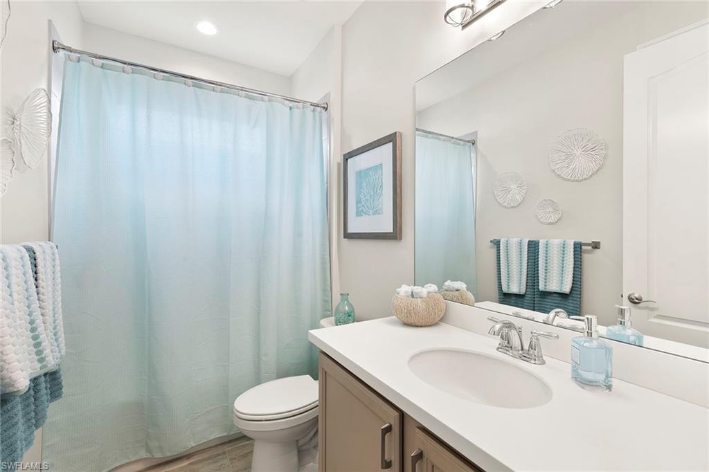 14796 Windward Lane Naples, FL 34114 - Photo 25 of 50 a bathroom with a sink toilet and a mirror